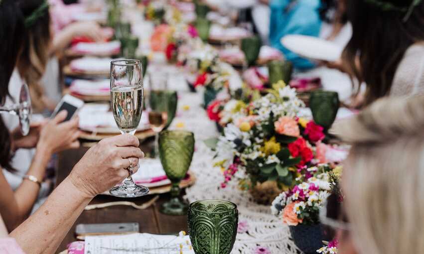 Raised glasses over table