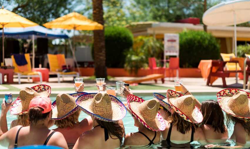 Group of girls in a pool celebrating a bachelorette party